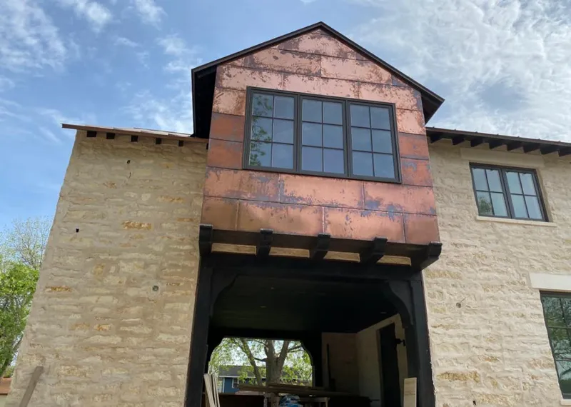 Copper metal panel facade on a stone building for Skylight Installation in Rosemont