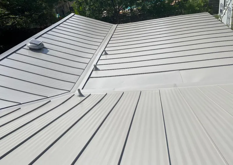 Solar attic fan installed on a metal roof for Roof Ventilation in Rosemont